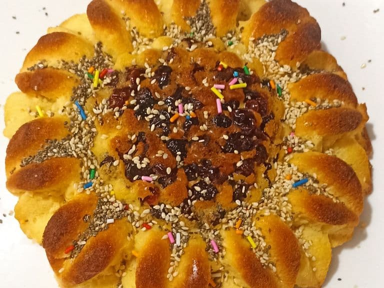 Ponqué artesanal en forma de girasol con uvas pasas, chía y ajonjolí